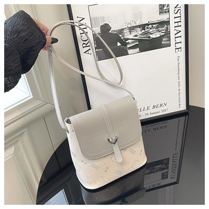 Detail of white mini bucket bag with blue cat patterns and silver heart magnetic closure