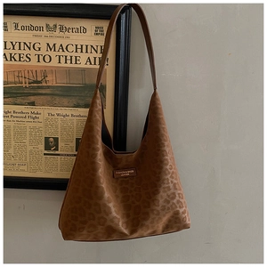 Close-up of vintage leopard print tote bag with gold stamped fashion leather label