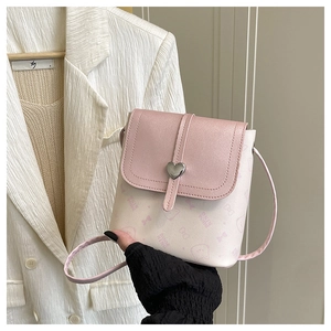 Close-up of pink PU leather flap with heart-shaped metal clasp and cartoon prints