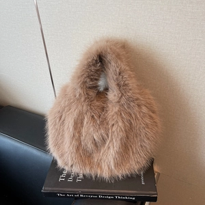 Brown faux fox fur shoulder bag with soft plush texture and minimalist oval design