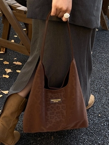 Brown leopard print tote bag with gold logo patch and slim shoulder straps for women