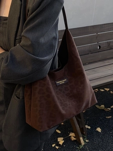 Chic dark brown leopard print oversized tote bag worn with stylish autumn outfit