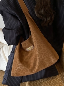 Brown large tote bag with leopard embossed suede texture and stylish leather logo patch