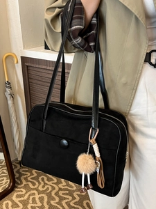 Large black suede shoulder bag for women featuring a minimalist tote design and plush pendant