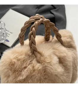 Detail of plush faux fur crossbody bag with unique woven leather circular handles