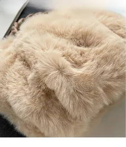 Detailed close-up of soft beige faux fur fabric texture for chic winter plush handbags