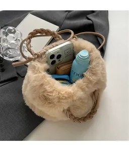 Spacious interior of light brown plush bucket bag showing daily essentials and soft texture