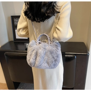 Detailed view of lavender faux fur cloud bag with a braided handle and soft texture
