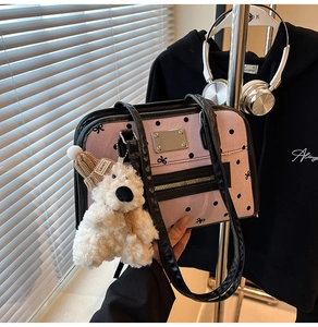 Detail of pink canvas tote with black polka dots, bow patterns, and a cute teddy bear charm