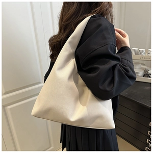 Detailed close-up of a large beige hobo tote bag with premium pebble grain leather texture