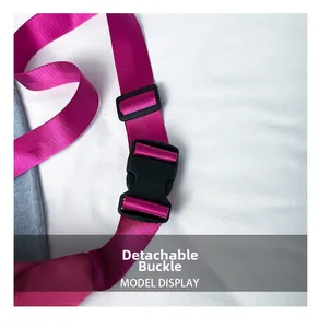 Detail of the durable black plastic release buckle on a pink nylon shoulder strap