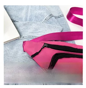 Detail view of smooth nylon zippers and durable fabric on this pink crossbody bag