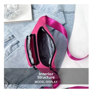 Detail view of pink nylon waist bag with multiple zippers and grey fabric interior lining
