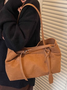 Brown suede tote bag with leather straps on model, 2025 minimalist autumn fashion style
