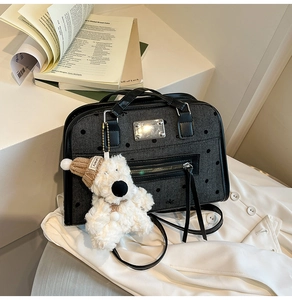 Close-up of vintage large capacity dark grey tote with cute plush bear charm detail