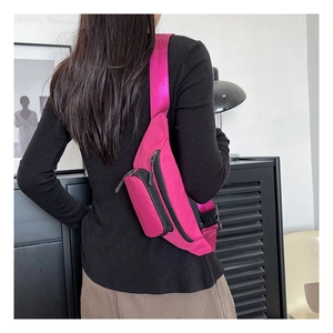 Back view of a model wearing a rose red waterproof oxford fabric crossbody bag