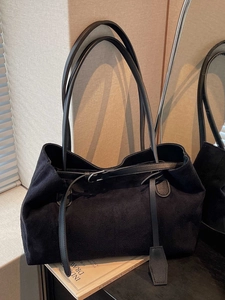 Large black suede tote bag for women with slim straps and decorative buckle in cozy interior