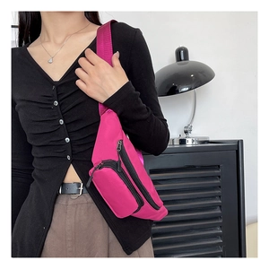 Macro view of waterproof magenta oxford cloth chest bag with multiple zipper compartments