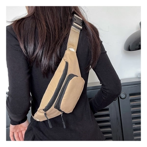 Rear view of khaki waterproof oxford fabric chest bag with dual zipper compartments