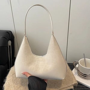 Minimalist beige leather hobo shoulder bag with matte texture and embossed logo
