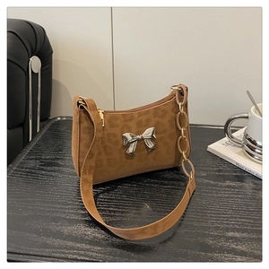 Close-up of vintage leopard print crossbody bag featuring a silver metal butterfly bow