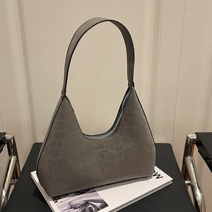 Chic dark gray suede hobo bag with top metal zipper and minimalist shoulder strap