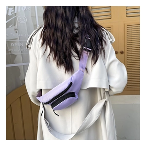 Detail of light purple nylon waist bag with double pockets and adjustable strap on a model