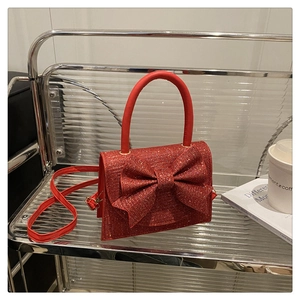 Sac de soirée rouge pailleté avec grand nœud décoratif et poignée ronde élégante