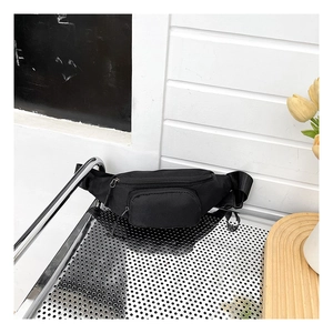 Detail of waterproof black nylon chest bag with adjustable strap and dual zip compartments