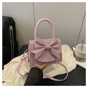 Mini borsa rosa glitterata con grande fiocco e tracolla rimovibile per occasioni