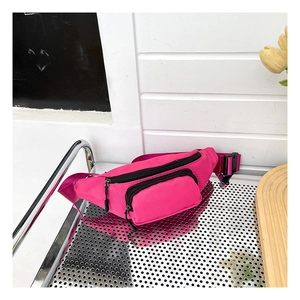 Detail view of pink nylon waterproof chest bag with adjustable strap and buckles