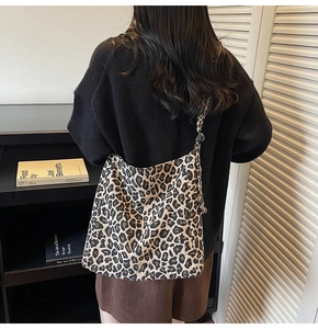 Detail of leopard print canvas tote bag featuring large capacity and Fashion side label