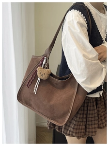 Brown faux suede hobo bag featuring a cute plush bear pendant and braided rope detail