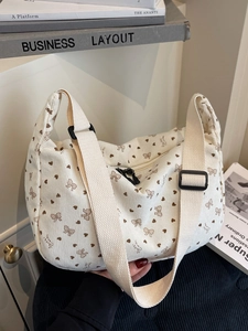Chic beige corduroy crossbody bag with heart and bow print and adjustable strap