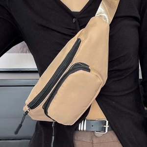 Waterproof khaki nylon waist bag with multiple zip pockets and gold webbing shoulder strap