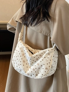 Creamy white corduroy crescent bag with brown floral heart patterns and bow details