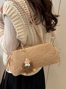 Fashionable brown plush shoulder bag for women with cute monster charm and leather drawstring