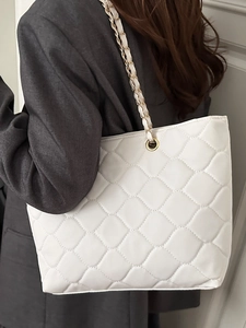 Large white quilted tote bag with gold chain strap shown from a stylish back perspective