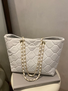 White quilted large tote bag with gold chain straps and classic rhombus pattern