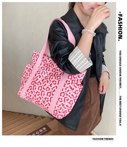 Detail of pink leopard print tote bag with wide strap and metallic front pocket closure