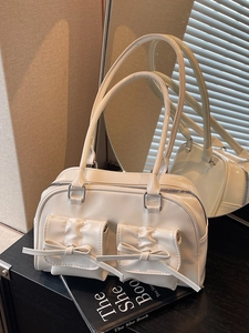 Fashionable cream PU shoulder bag with bow pockets and silver hardware baguette style
