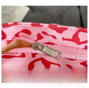 Macro shot of smooth silver metal zipper on pink leopard print canvas tote bag