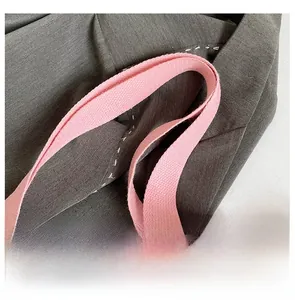 Detail view of pink woven handles and leopard print fabric on a stylish tote bag