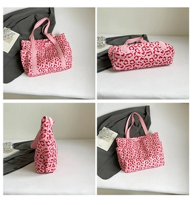 Detail view of pink leopard print tote bag with side pockets and canvas strap handles