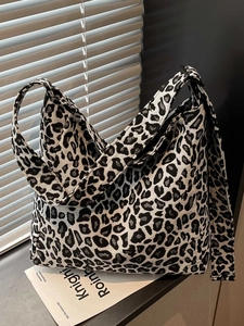 Stylish large capacity leopard print tote bag with wide strap on a window sill