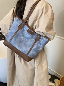 Retro canvas tote bag with brown leather trim and fashion label shown on model