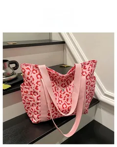 Detail view of pink leopard print canvas tote with side pockets and magnetic snap closure