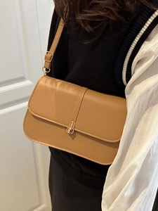 Chic tan leather baguette bag with gold metal clasp for modern women's daily commute