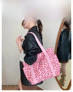 Pink leopard print tote bag shown on a model featuring stylish shoulder straps