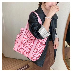 Close-up of pink leopard print tote bag with side pocket and magnetic snap closure